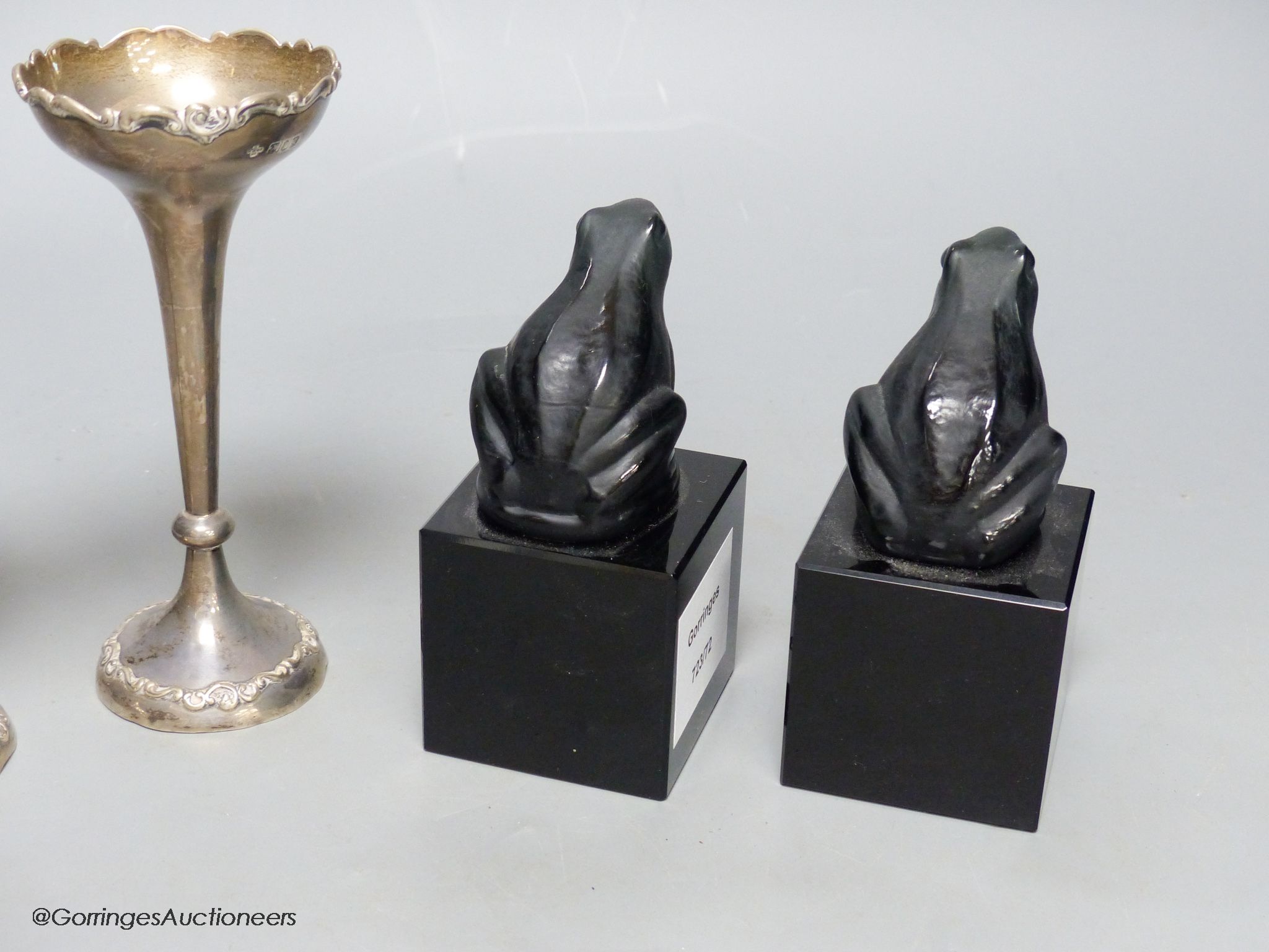A pair of silver specimen vases, height 14cm, and a pair of black glass frogs